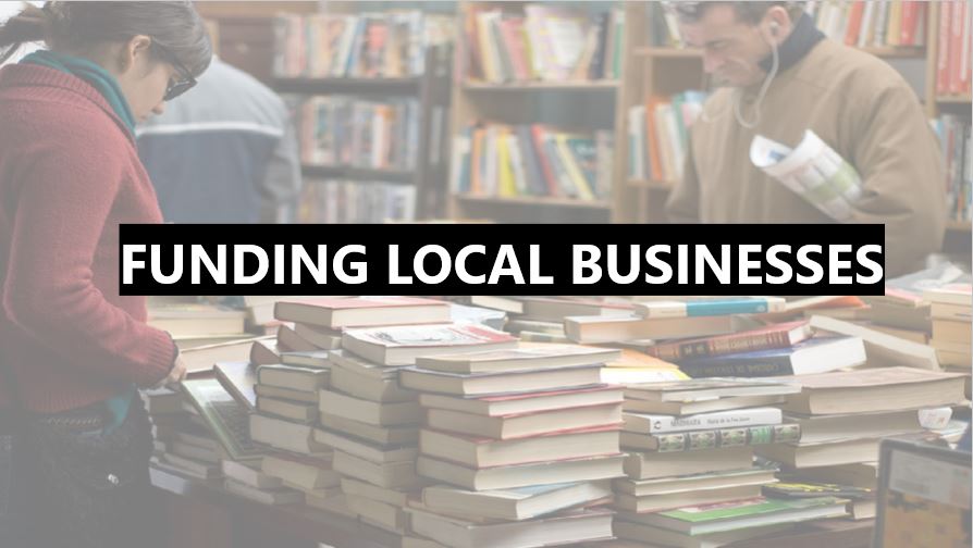 An image of three people shopping at a locally owned bookstore with the text, 